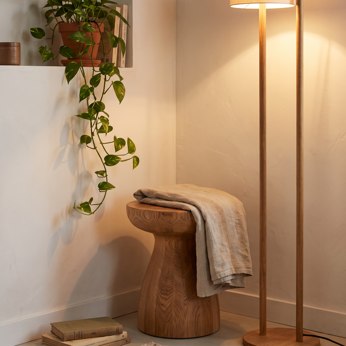 Timber stool and wooden floor lamp in a warm corner